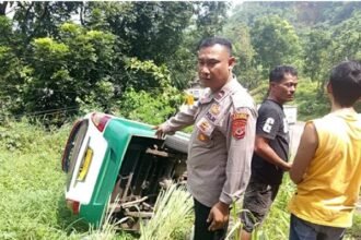 Petugas mengevakuasi angkot terguling di Tanjakan Baeud Warungkiara. (Prima Arno/Telusurbisnis)