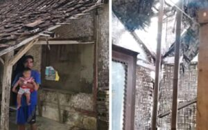 Ketua RT Dadan bersama bayinya di depan rumahnya yang nyaris ambruk. (Prima Meidiandi/Telusurbisnis)