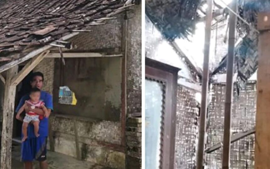 Ketua RT Dadan bersama bayinya di depan rumahnya yang nyaris ambruk. (Prima Meidiandi/Telusurbisnis)